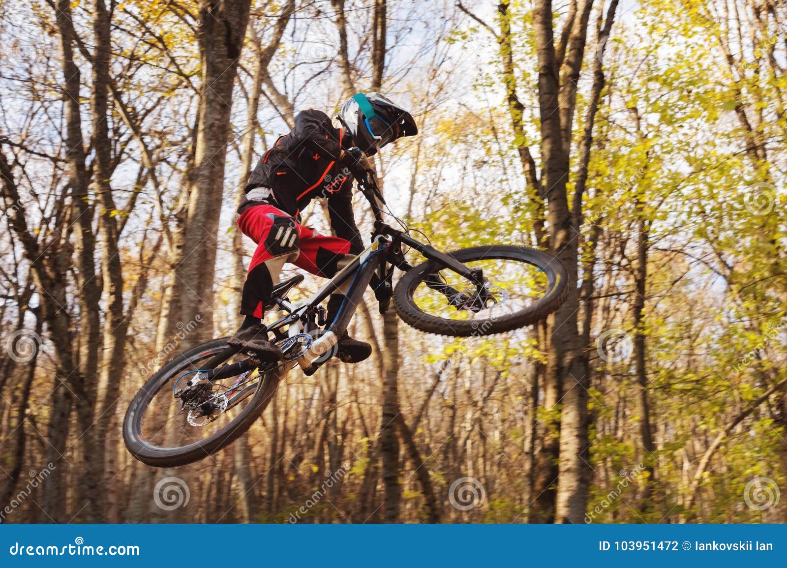 A Young Rider at the Wheel of His Mountain Bike Makes a Trick in ...