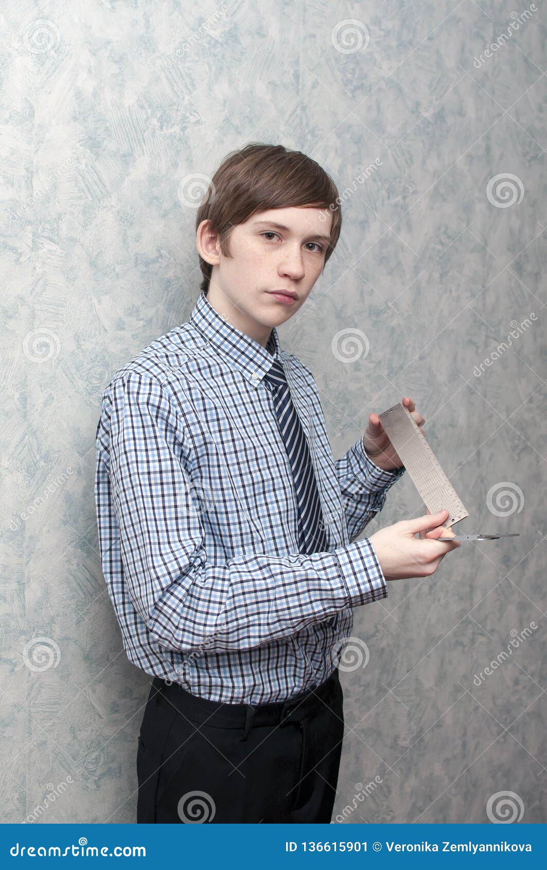 The Young Russian Guy Holds a Caliper and a Metal Ruler in Hand Stock