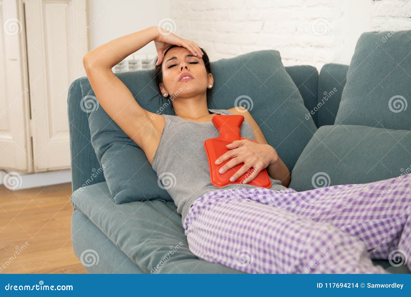 young sad attractive woman having painful stomachache from period pain and menstrual cramps