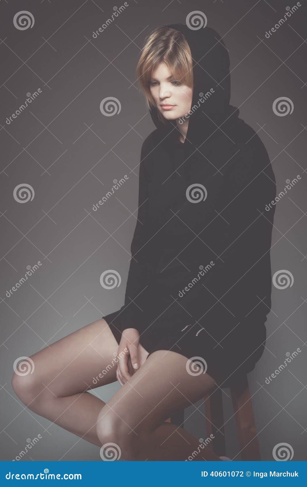 Young sad woman in black hood