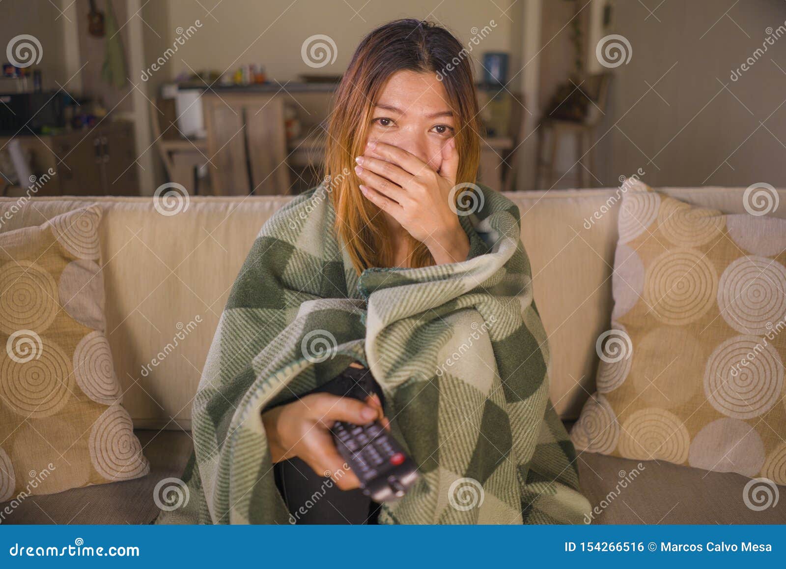 Young Scared Or Surprised Asian Indonesian Woman Watching Television