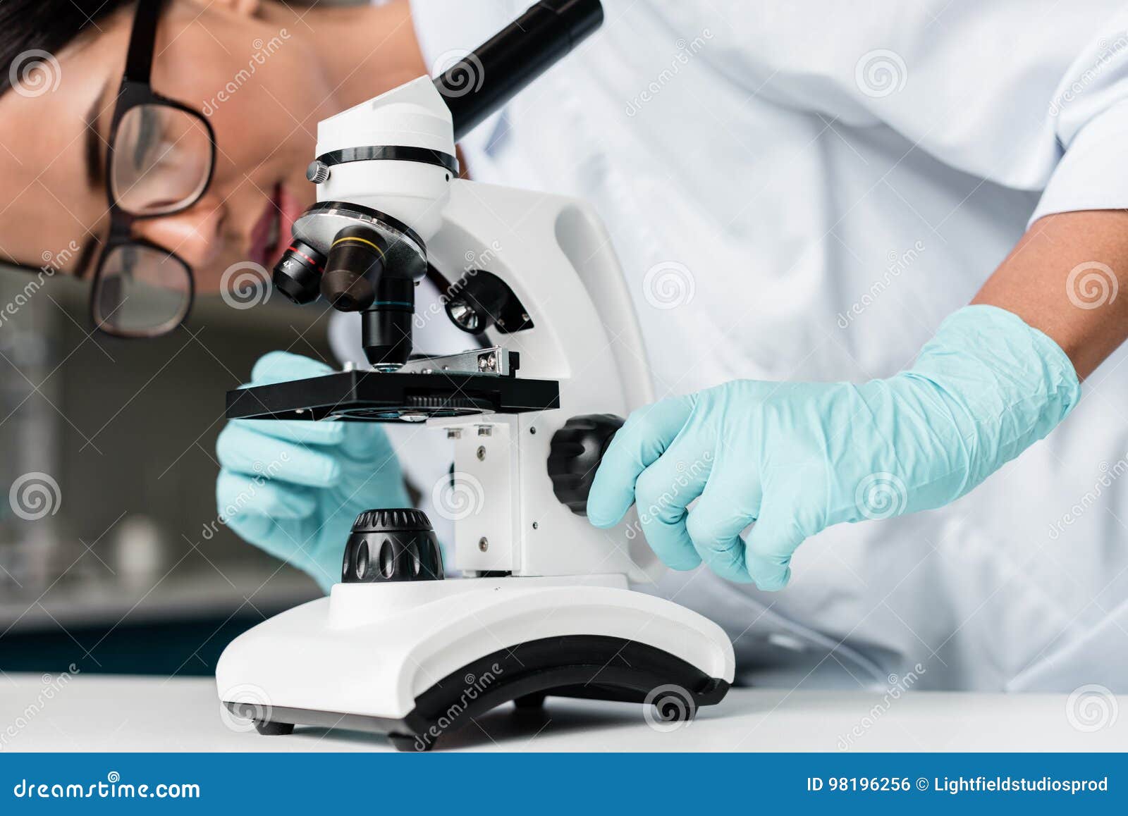 Young Scientist in Eyeglasses and Protective Gloves Working with