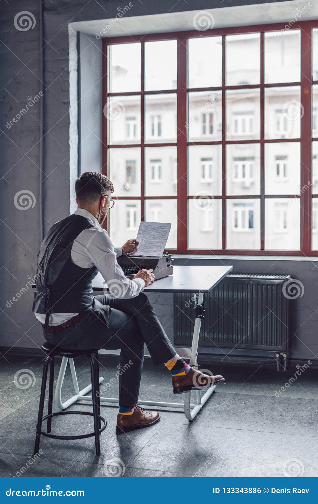 young screenwriter reading the script by the window