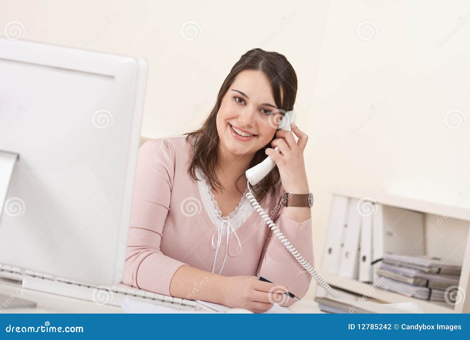 young secretary on phone at modern office