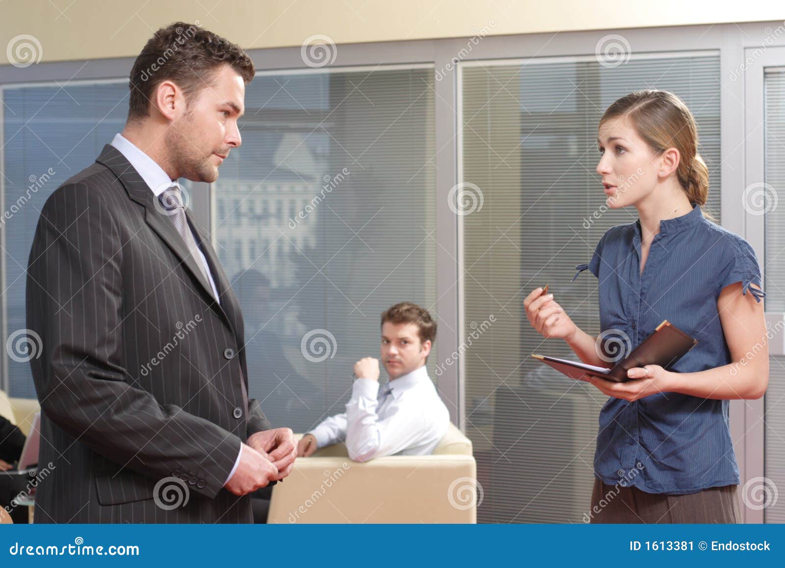 young secretary talking to her boss in the office