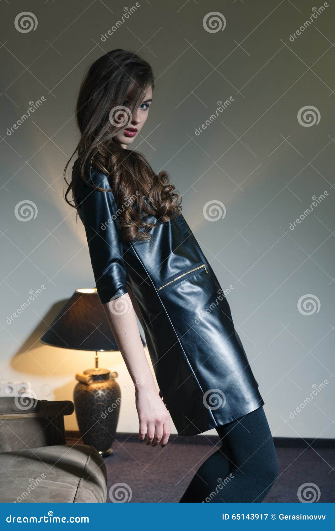 Young Seductive Woman In A Black Leather Dress Stock Photo 