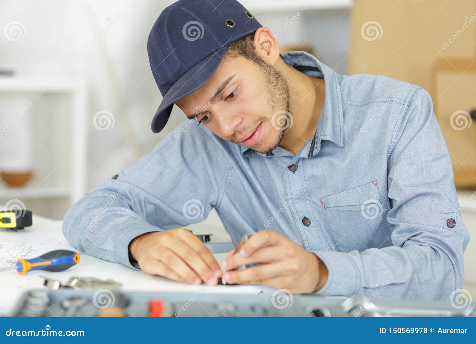 Young Serviceman Assembling Parts Stock Photo Image of person