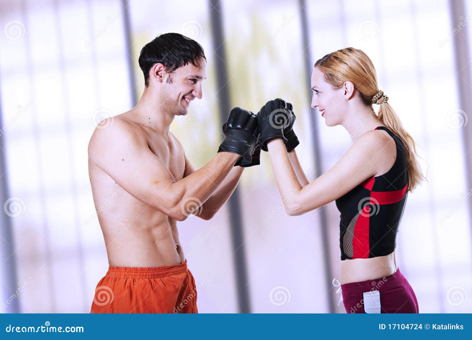 Young Sexual Couple Fighters Smiling Stock Photo photo