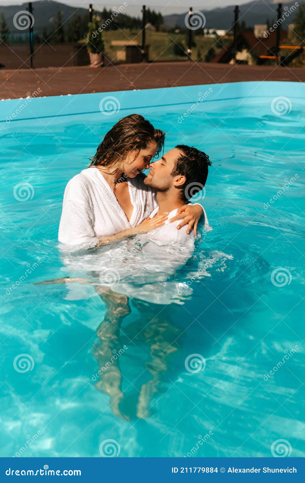 Naked asian girls kissing in a pool