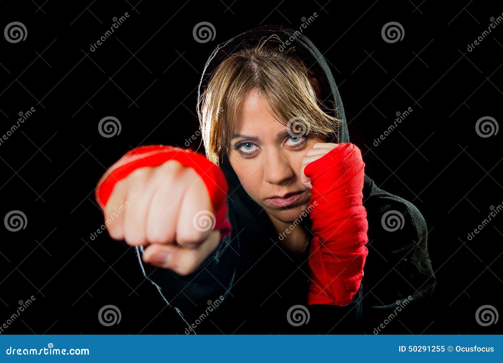 young dangerous girl shadow boxing with wrapped hands and wrists training workout