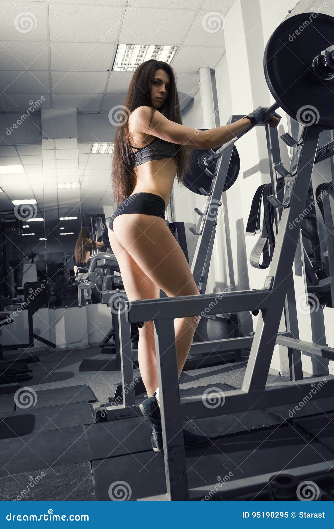 Young Fitness Girl Workout with Barbell in the Gym., Woman in