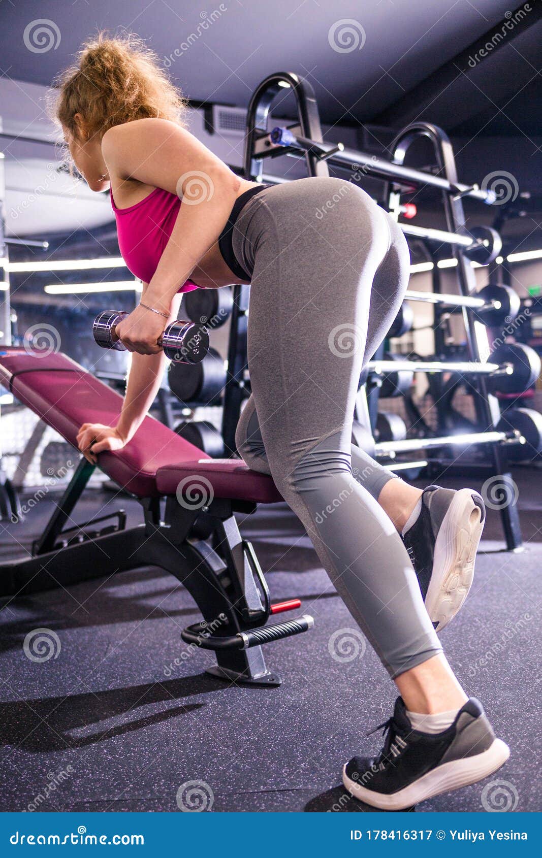 Young Fitness Girl Workout With Dumbbells On Athletic Bench In The Gym Brunette Woman In Sport 