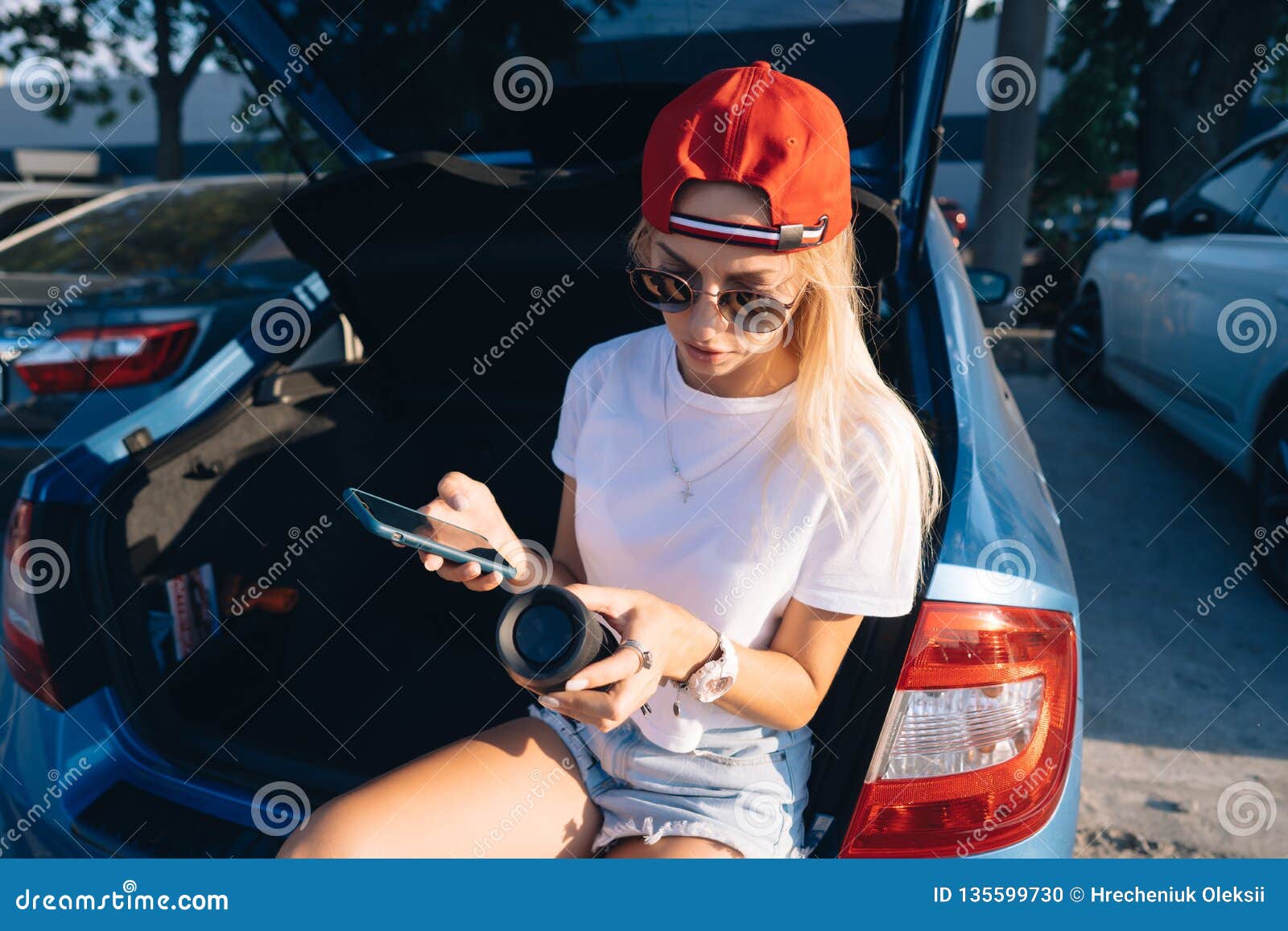 Premium Photo | Beautiful fashionable young woman in glasses posing near car