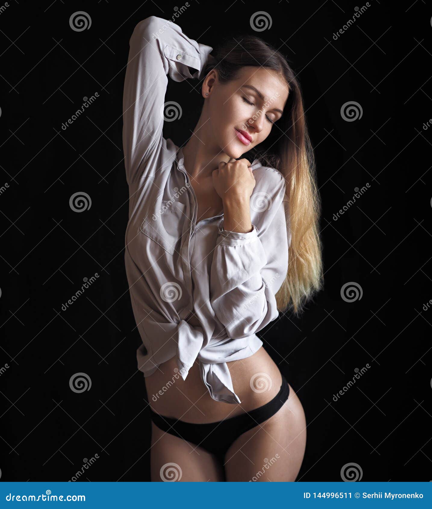 Young Girl Posing at Underwear Isolated at Black Stock Image photo