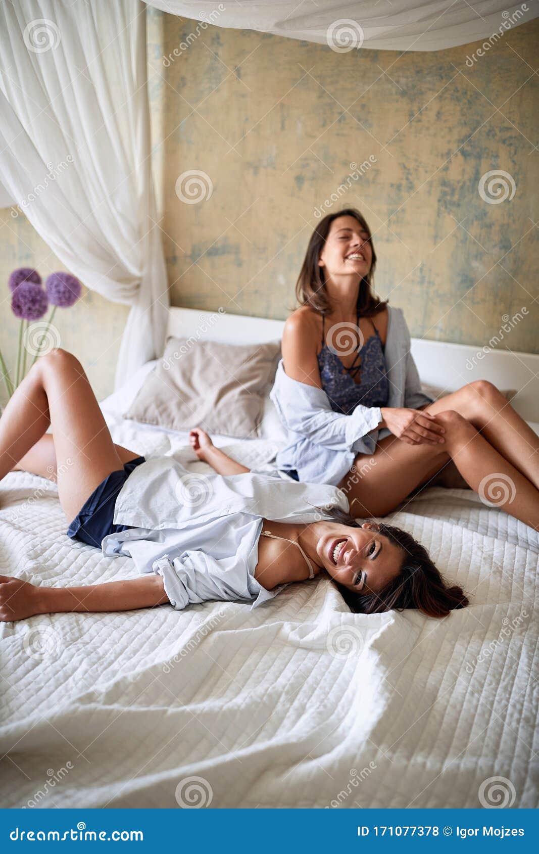 attractive passionate lesbians in black lingerie sitting in bedroom Stock  Photo