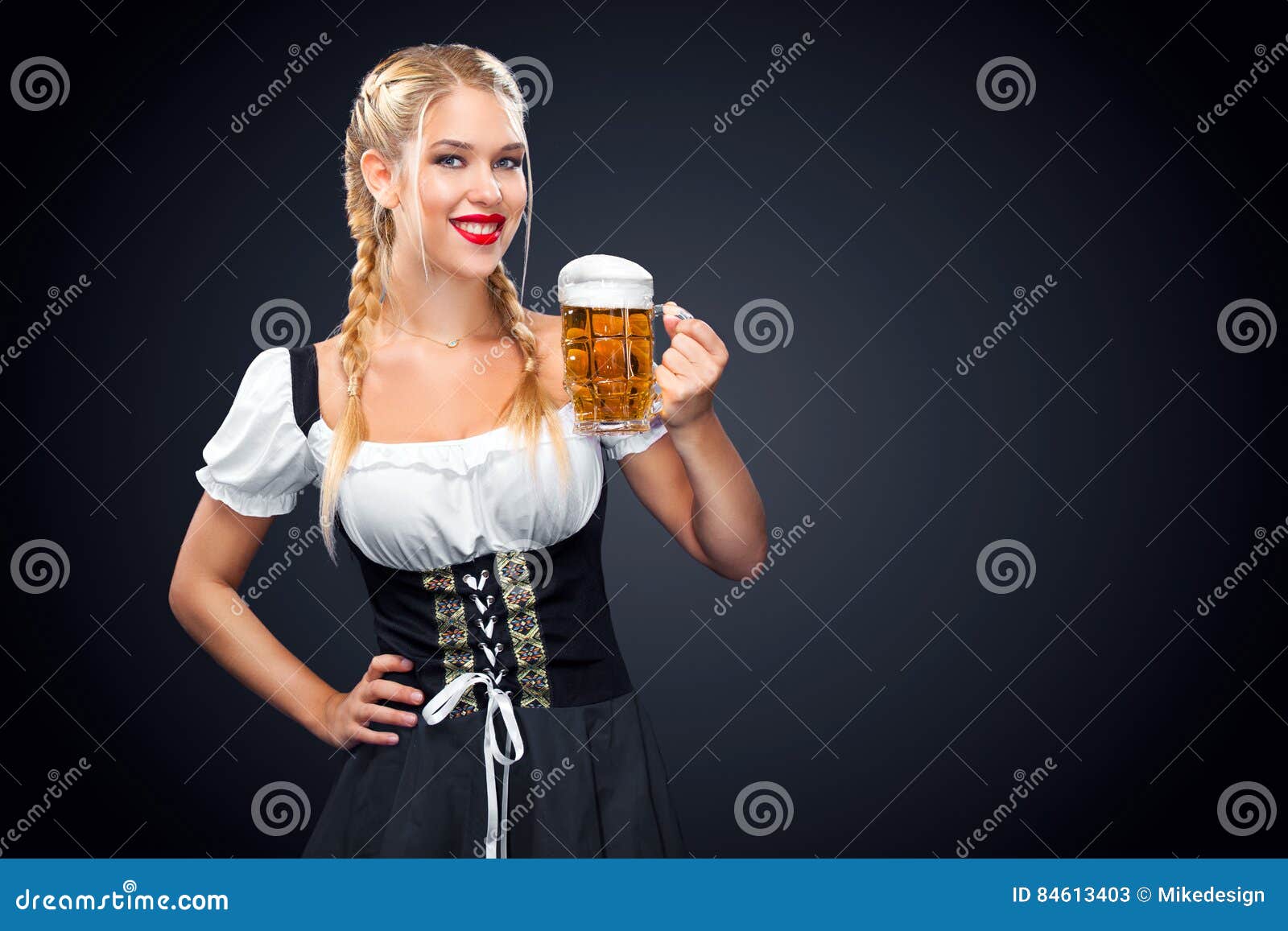 Young Oktoberfest Waitress, Wearing a Traditional Bavarian Dress ...