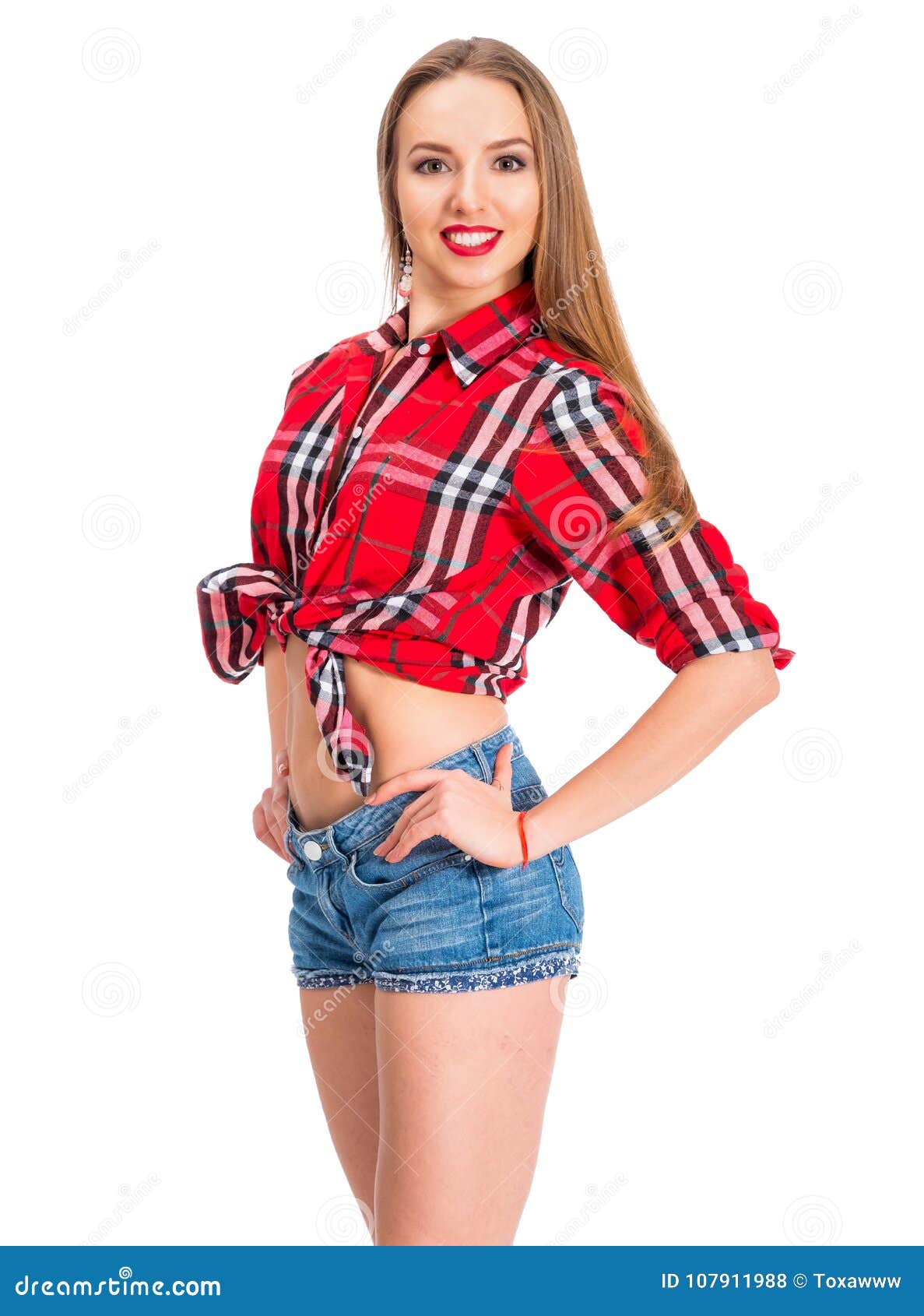 Young Woman Dressed in Denim Shorts and Checkered Shirt Posing in ...
