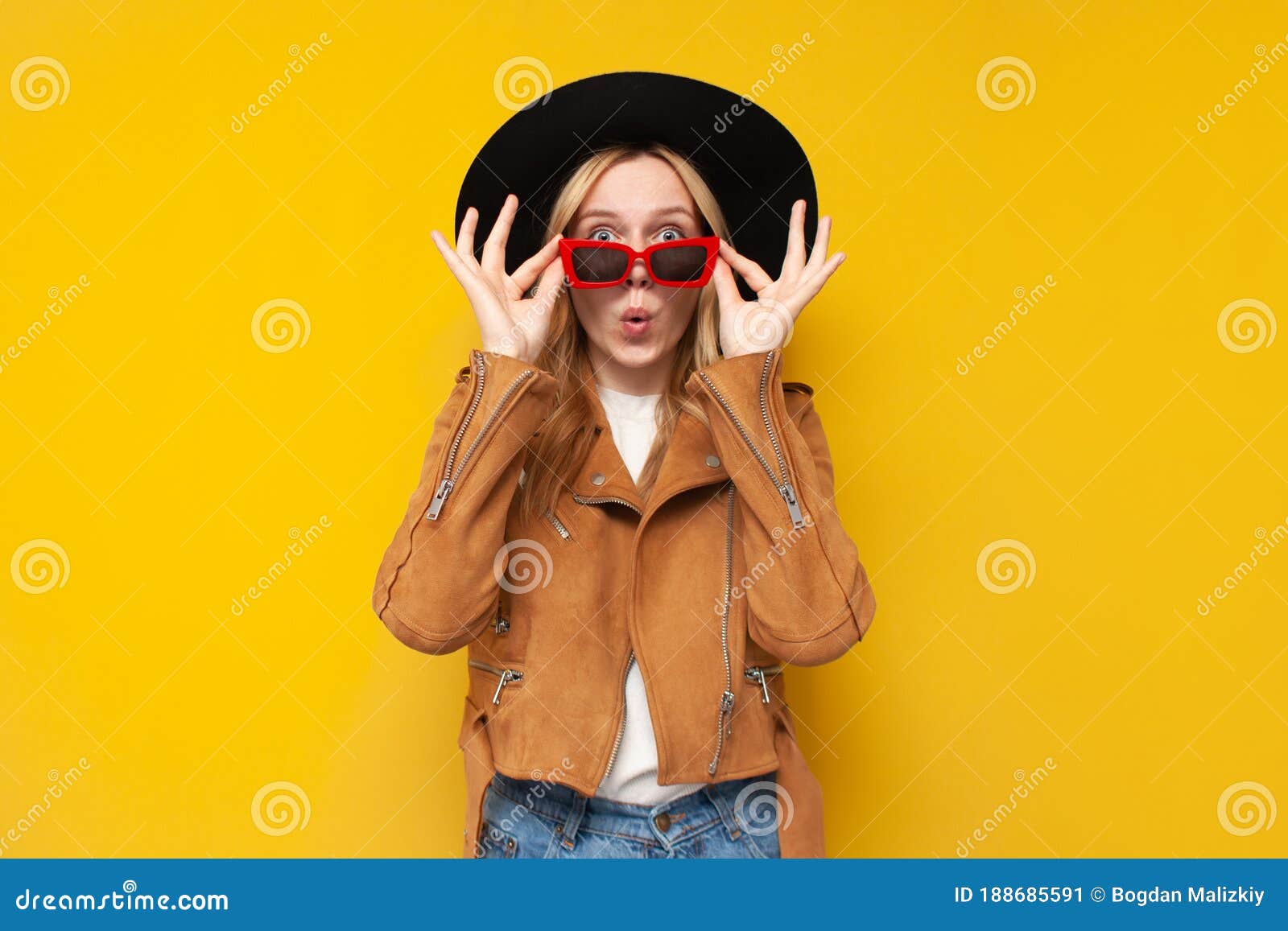 Shocked Girl In Autumn Clothes And Glasses Is Surprised At A Yellow