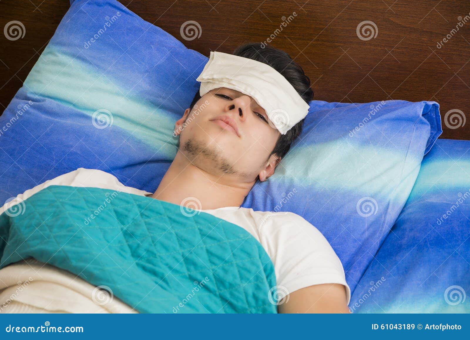 young sick or unwell man in bed