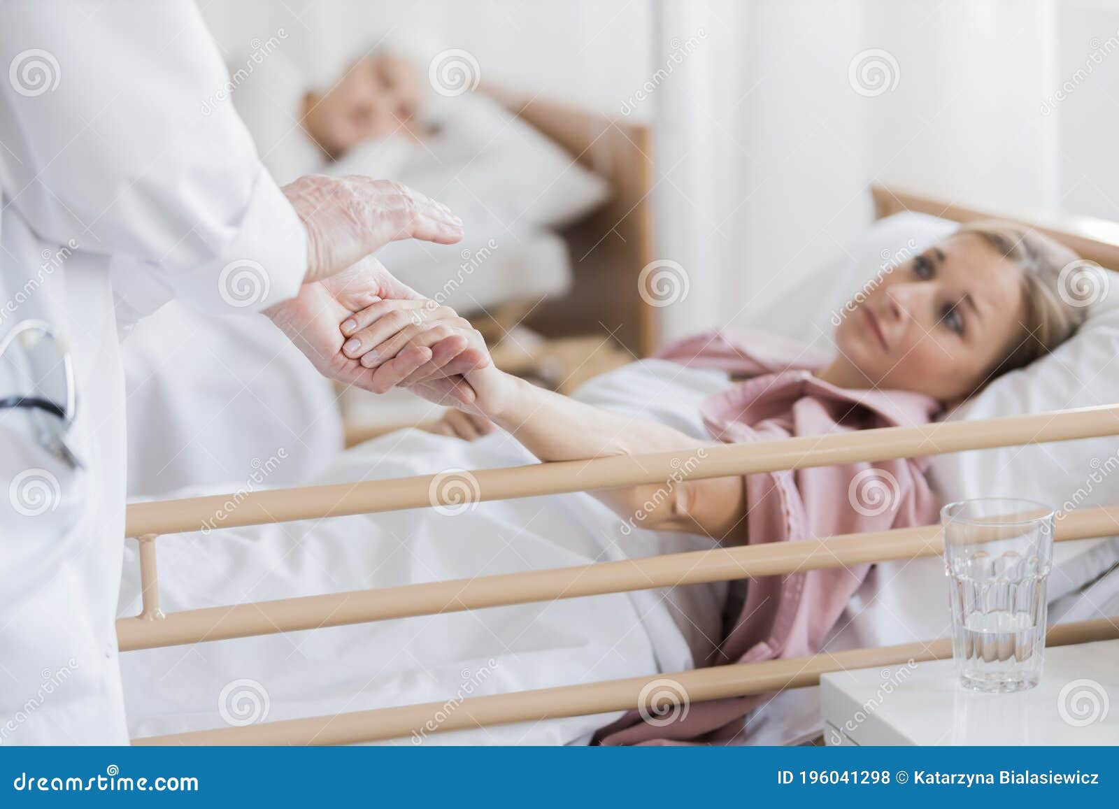 woman holding doctor`s hand