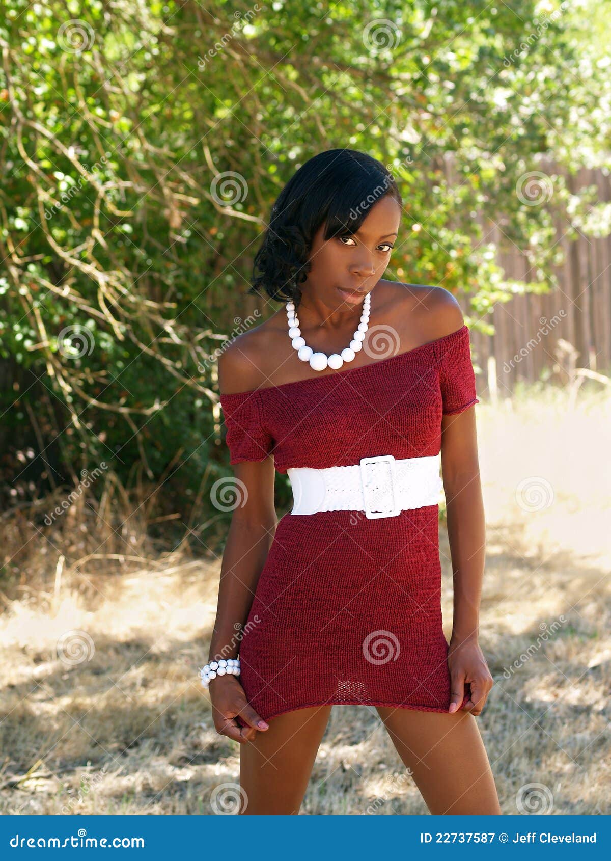 Fashion Woman in New York. Young African American Woman with long hair  dressing in red slim