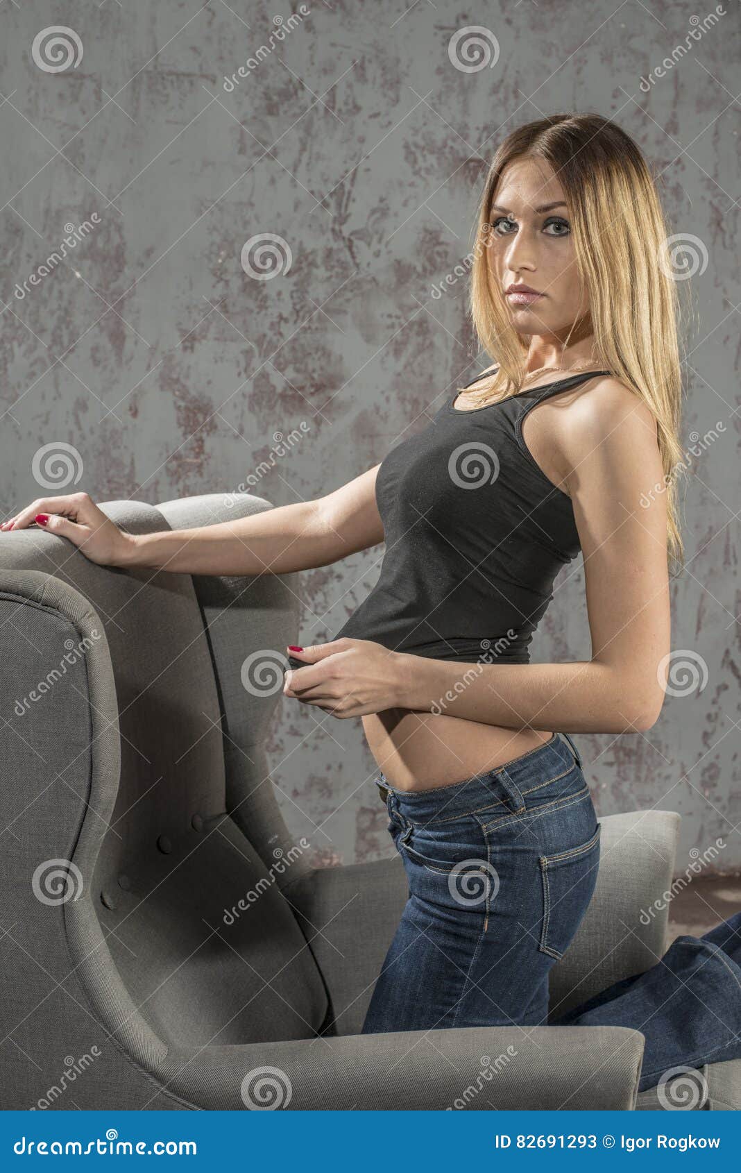 Young Slender Blonde Girl In Jeans And Shirt Posing Coquettishly Stock Image Image Of Face 