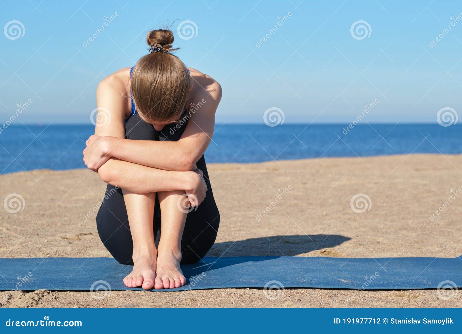Young Slender Girl Doing Yoga on the Beach on a Sunny Morning, Sad ...
