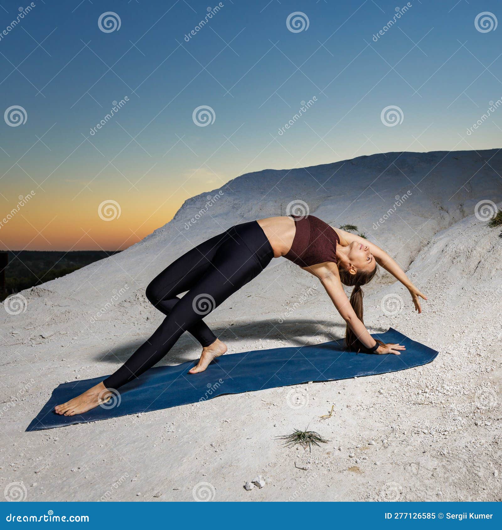 Woman doing Wild Thing yoga pose outdoors. Female practicing