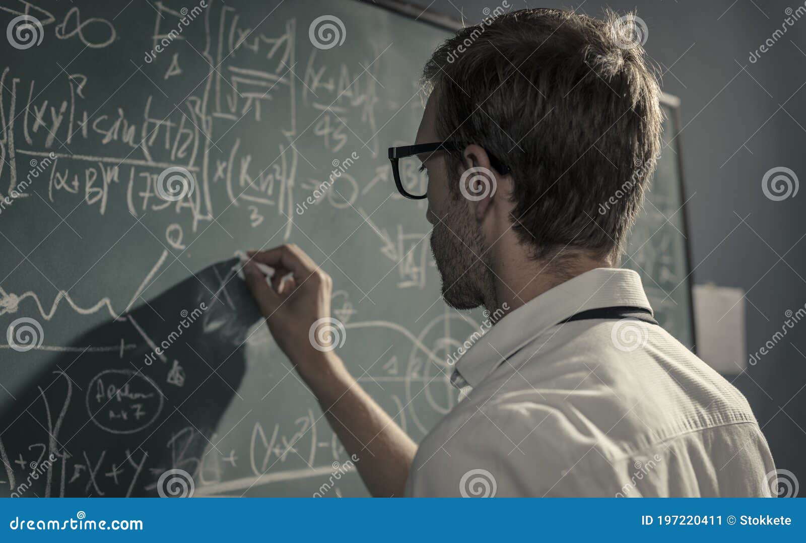 young smart mathematician drawing on the chalkboard