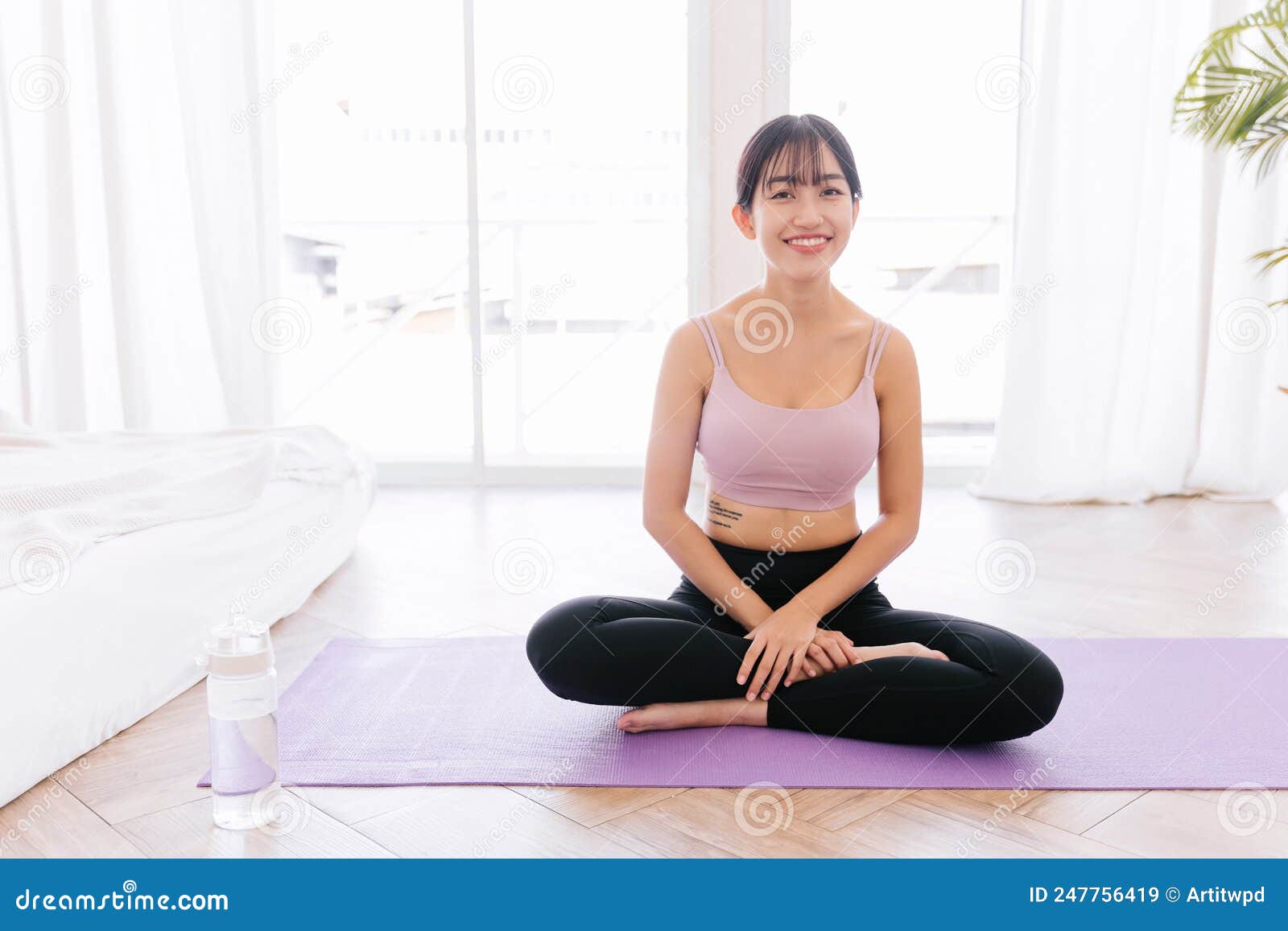 Young Smiling Attractive Sporty Asian Woman Practicing Yoga On Yoga Mat
