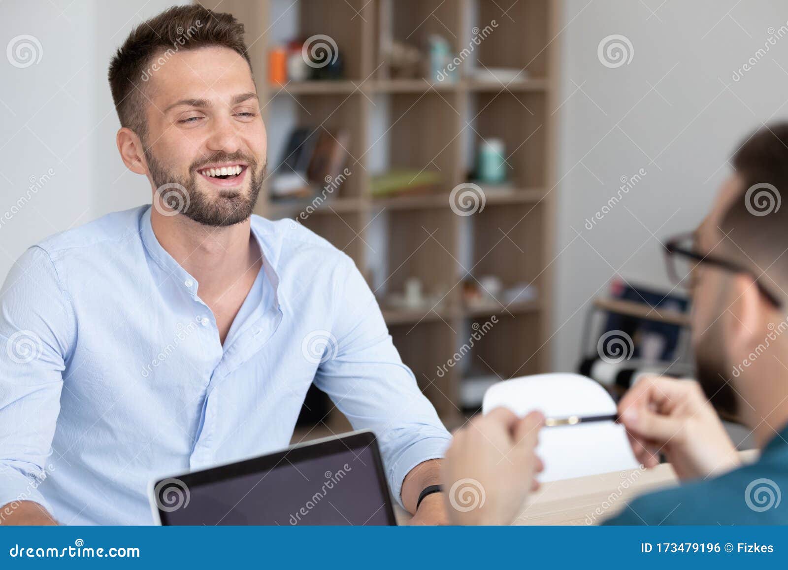young smiling man attending job interview with skilled hr manager.