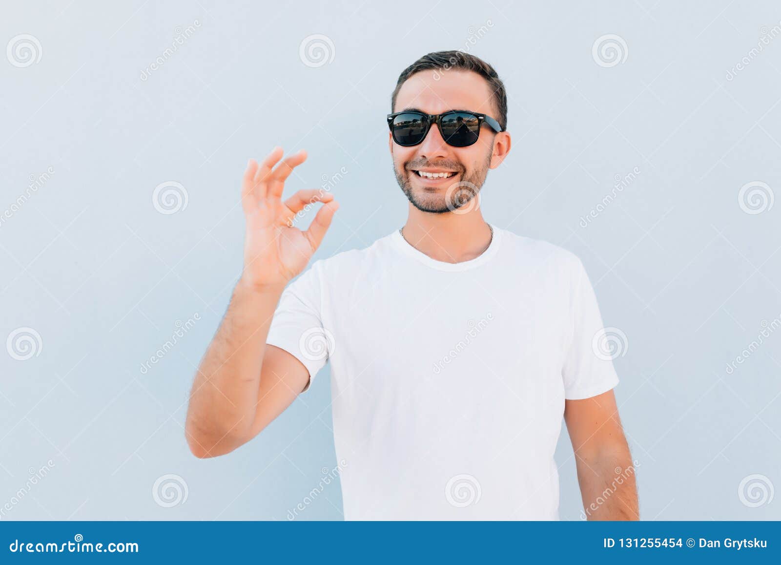 Young Smiling Man in Sunglasses Having Happy Look, Gesturing, Showing ...