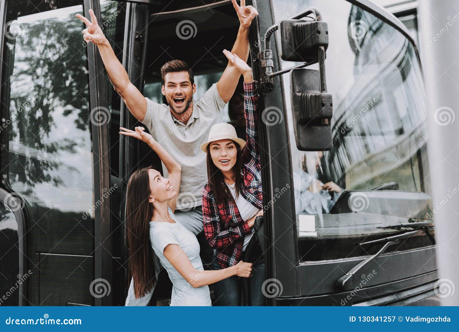 young smiling people traveling on tourist bus