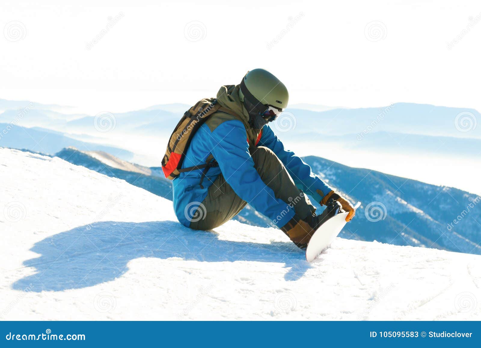 Young Snowboarder Tightening His Bindings Stock Image - Image of ...