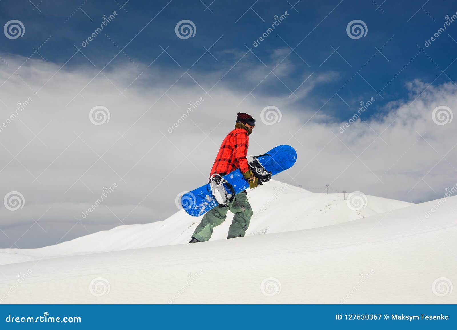 Young Male Snowboarder Walking Up the Hill with the Snowboard Stock ...