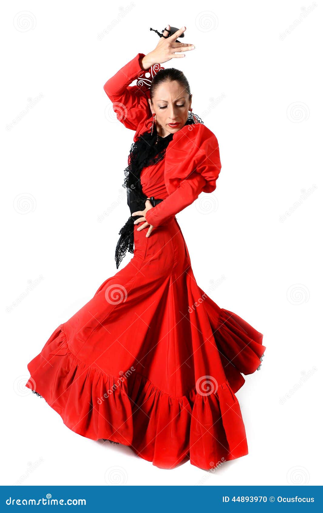 young spanish woman dancing flamenco with castanets in her hands