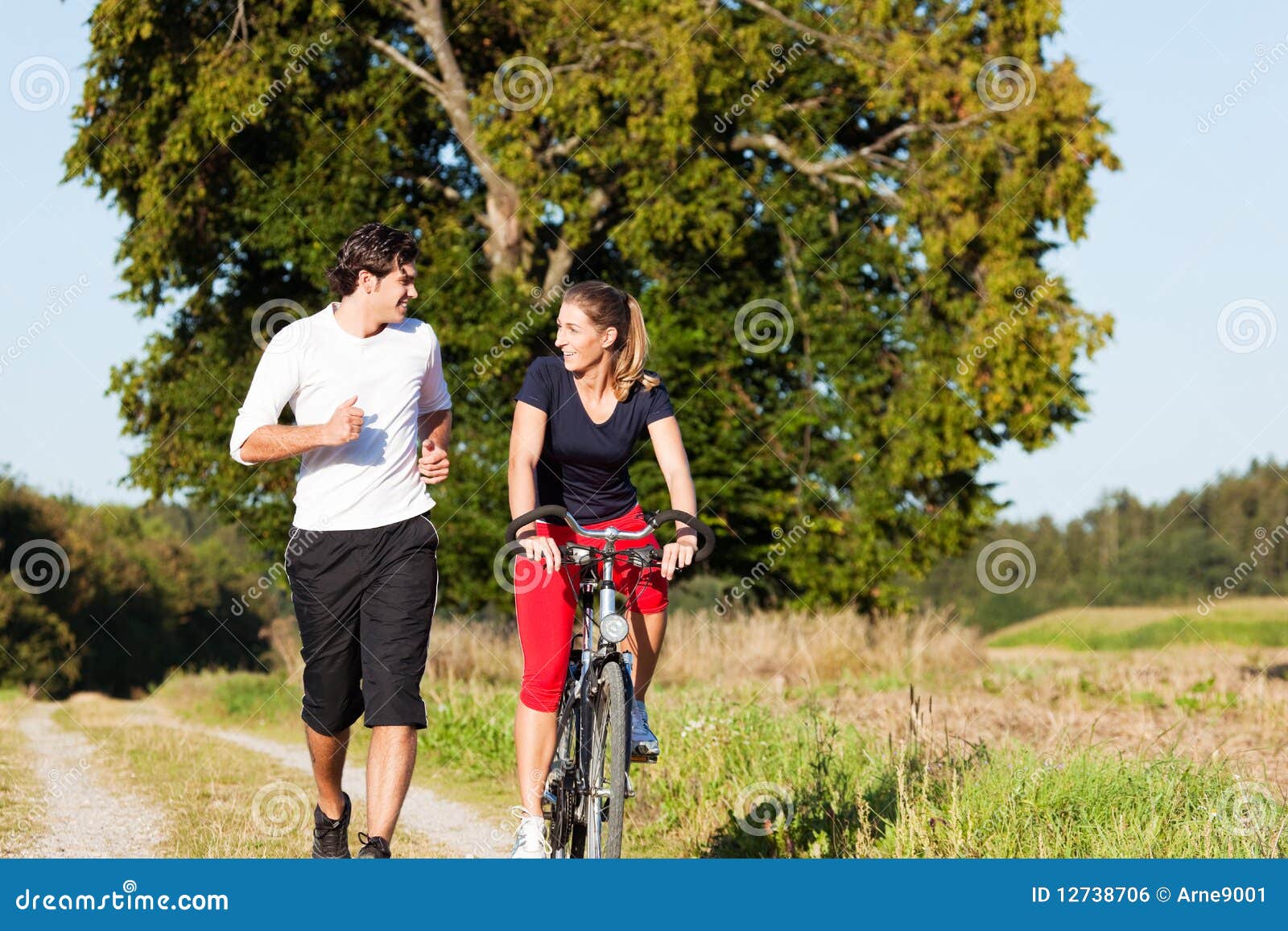 Young Sport Couple Jogging And Cycling Royalty Free Stock Image pertaining to Cycling Or Jogging