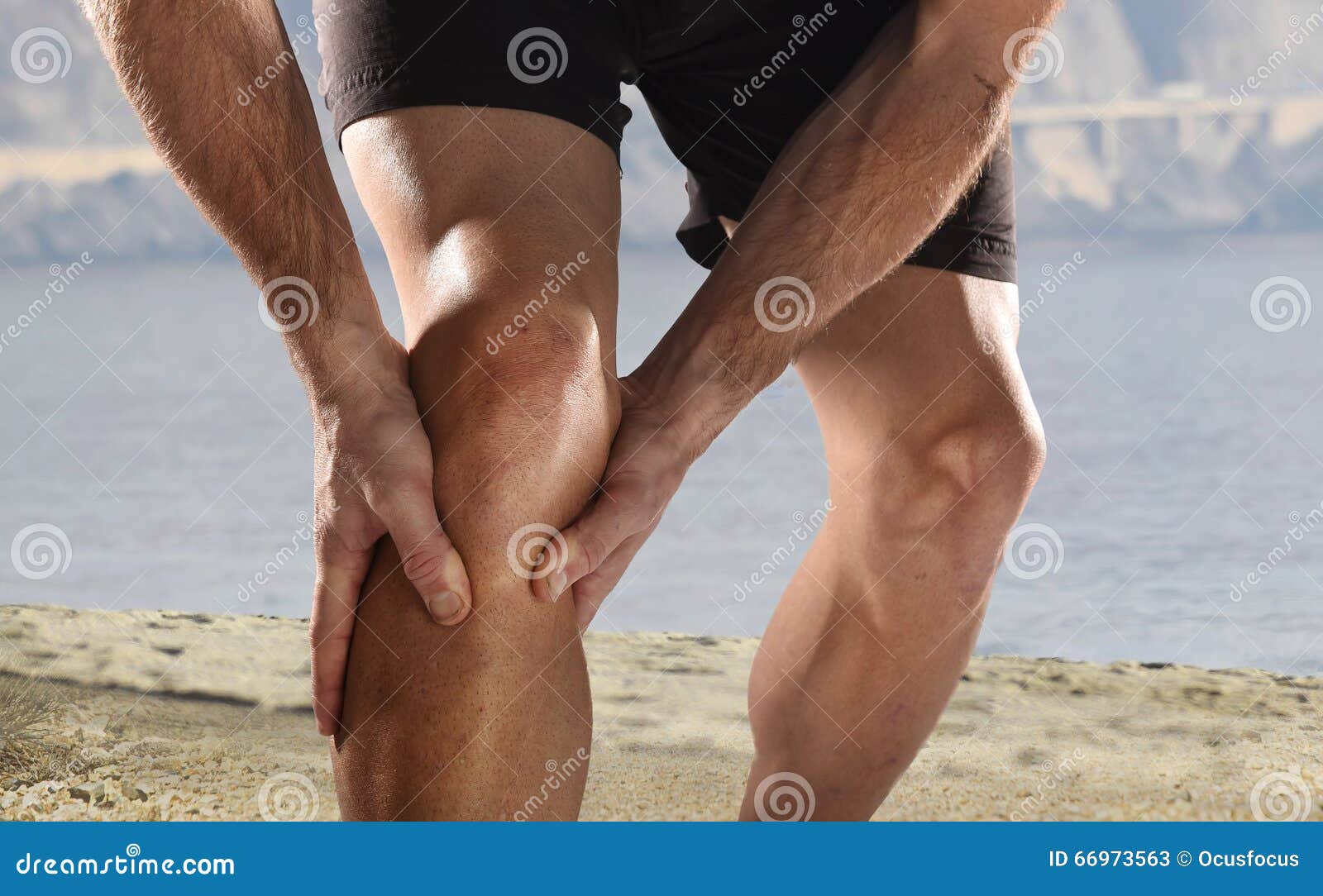 young sport man with athletic legs holding knee in pain suffering muscle injury running