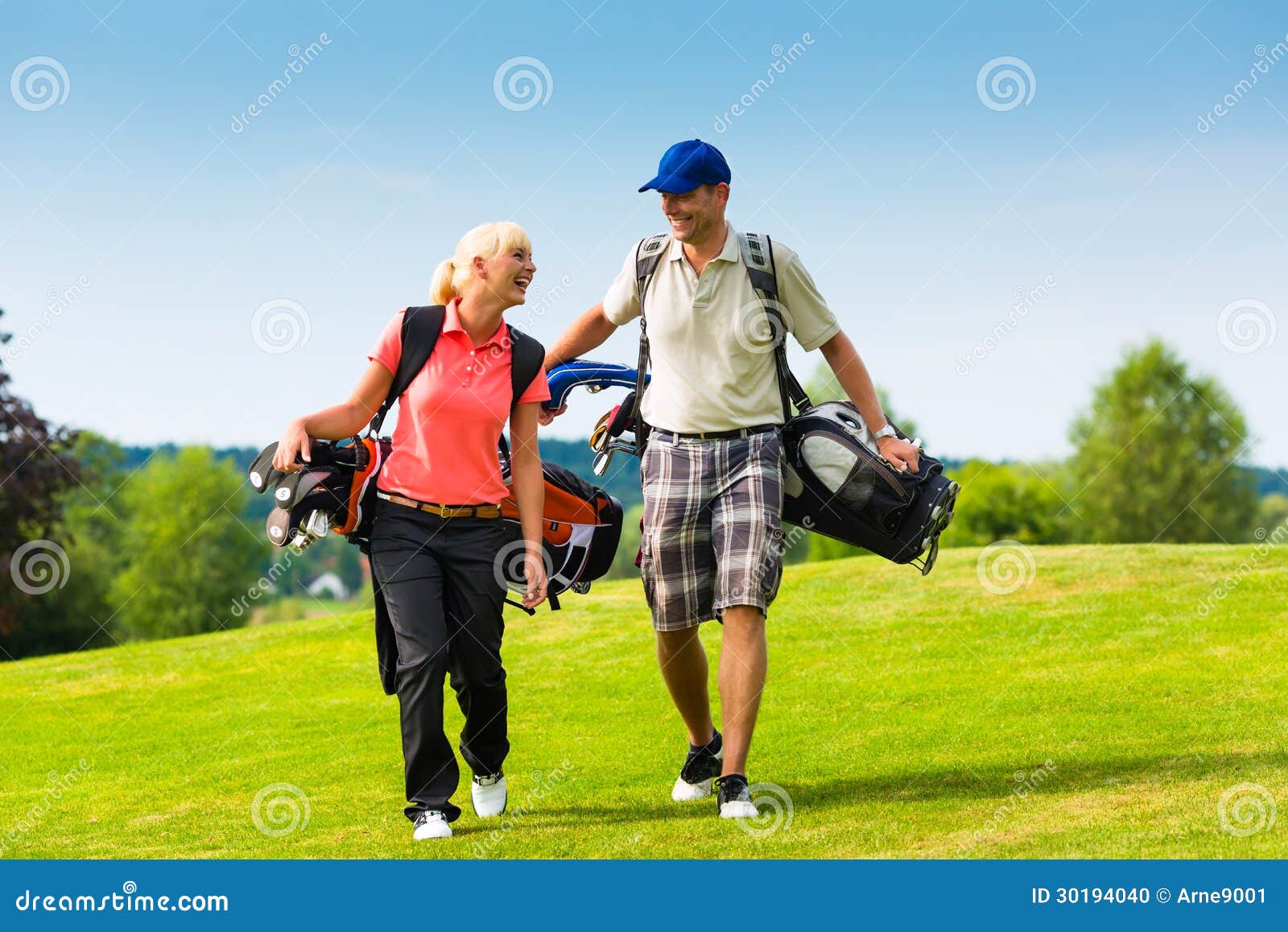 young sportive couple playing golf on a course