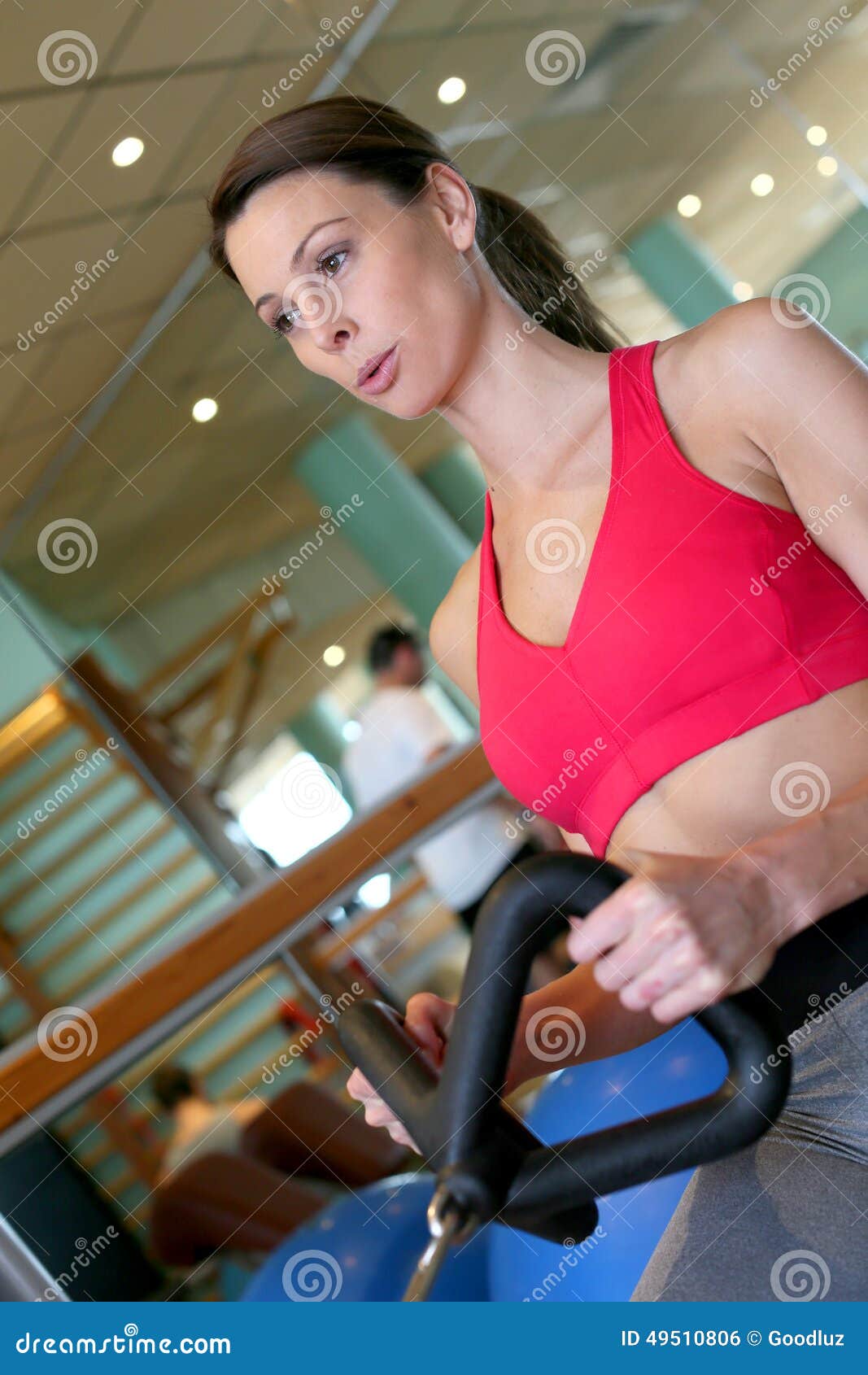 Young Sportive Woman Excercising on a Fitness Machine Stock Photo ...