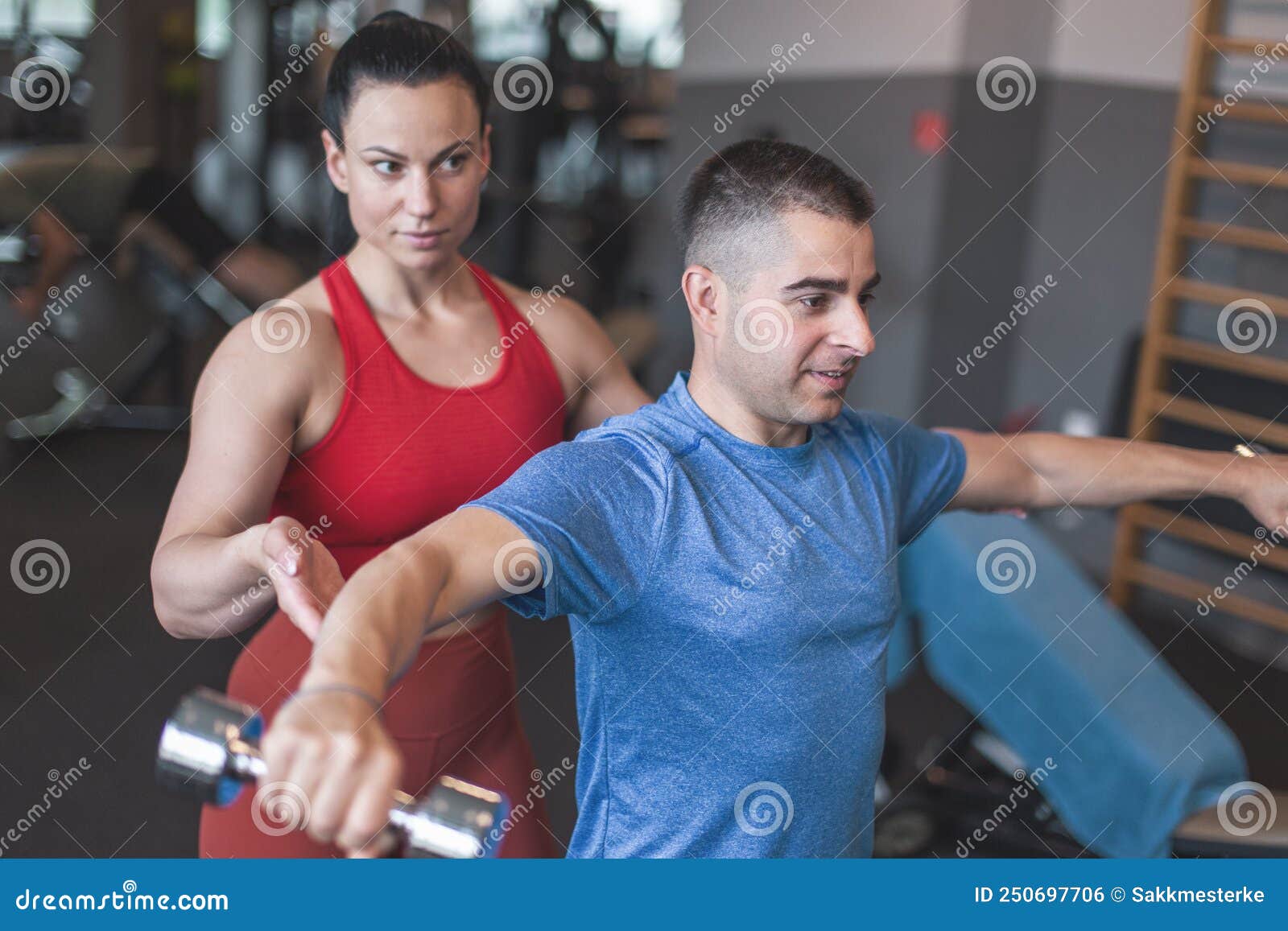 Young Sporty Personal Trainer Woman Holding Clients Elbow during ...