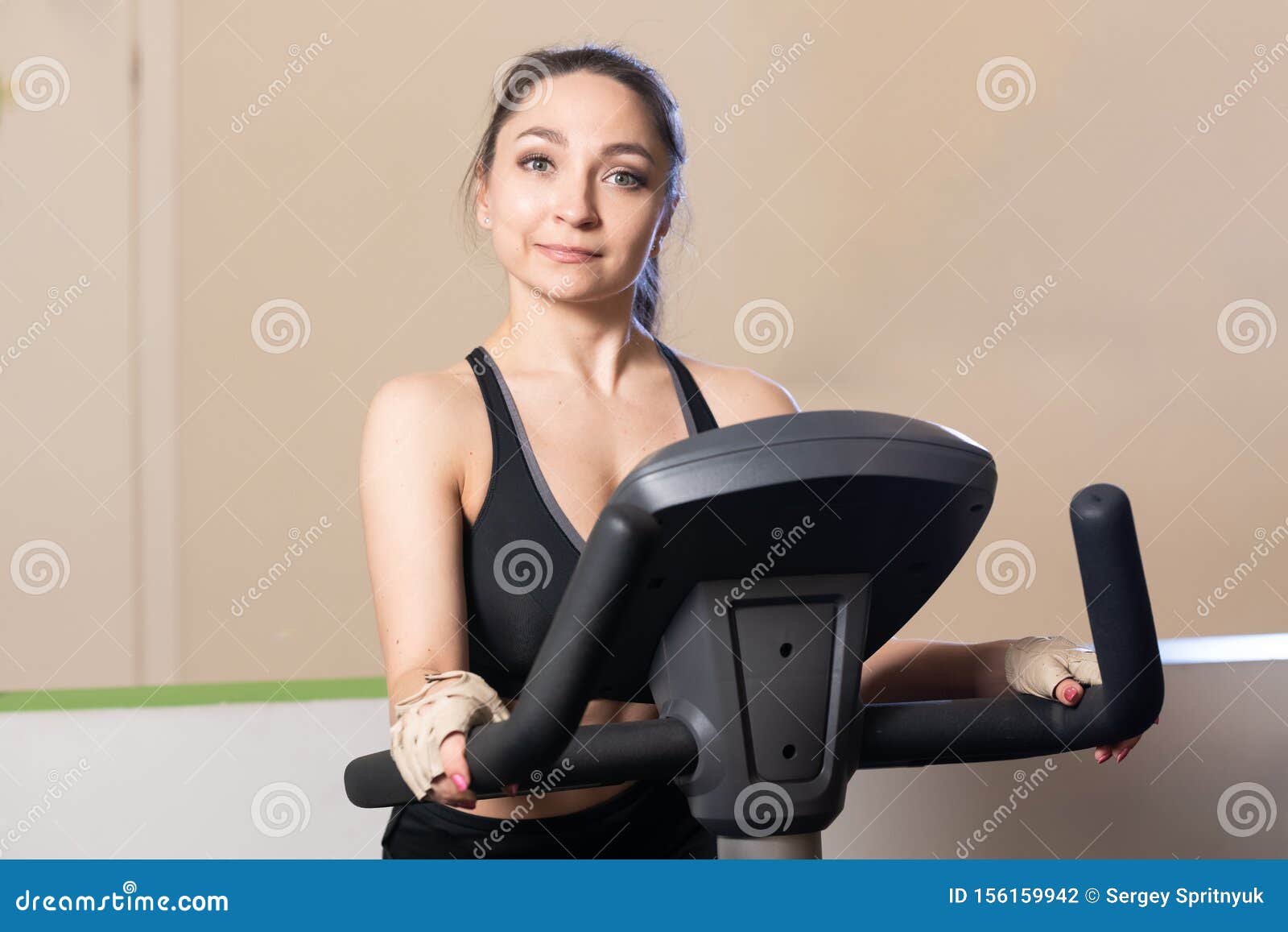 Young Attractive Girl At Gym On Exercise Bike, Fitness And 