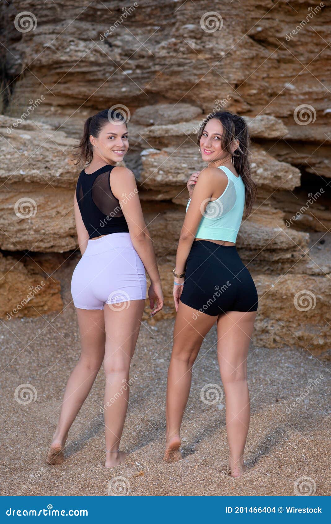 Young Sporty Girls Wearing Tight Workout Shorts and Crop Tops Standing on a  Rocky Cliff Stock Photo - Image of healthy, woman: 201466404
