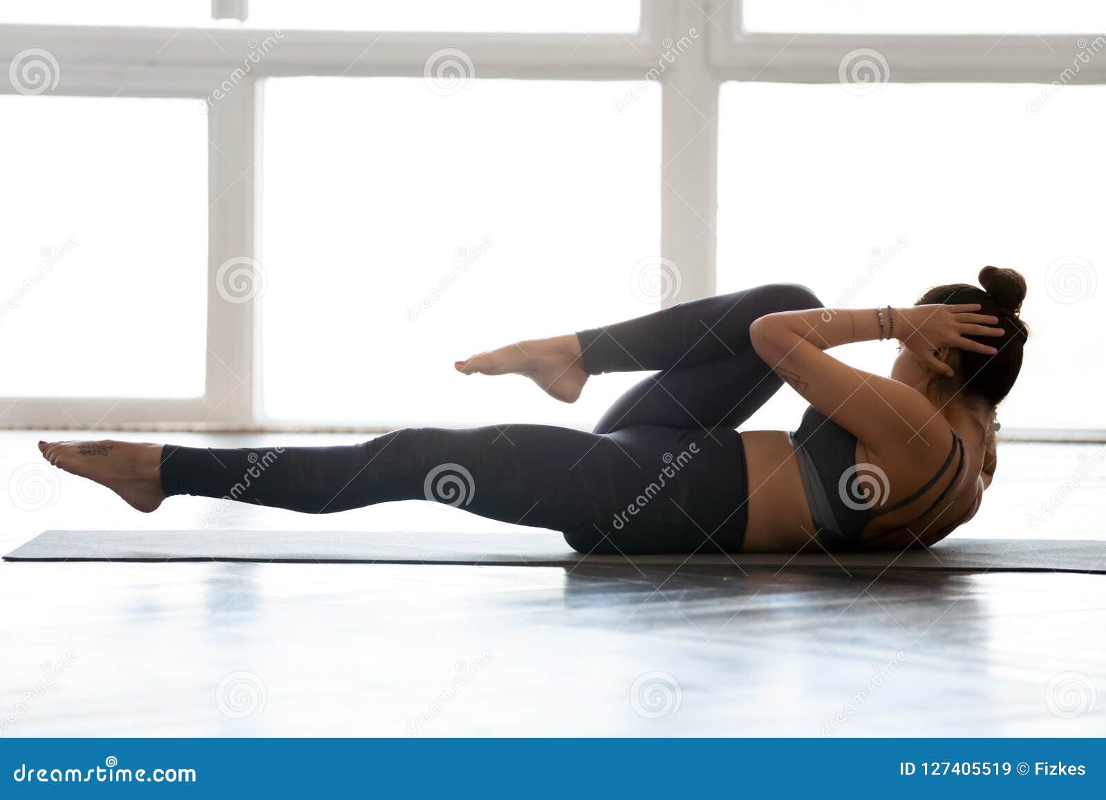 Sporty woman practicing, doing bicycle crunches exercise, crisscross pose,  working out, wearing sportswear, grey pants and top, indoor close up, sport  studio Stock Photo | Adobe Stock