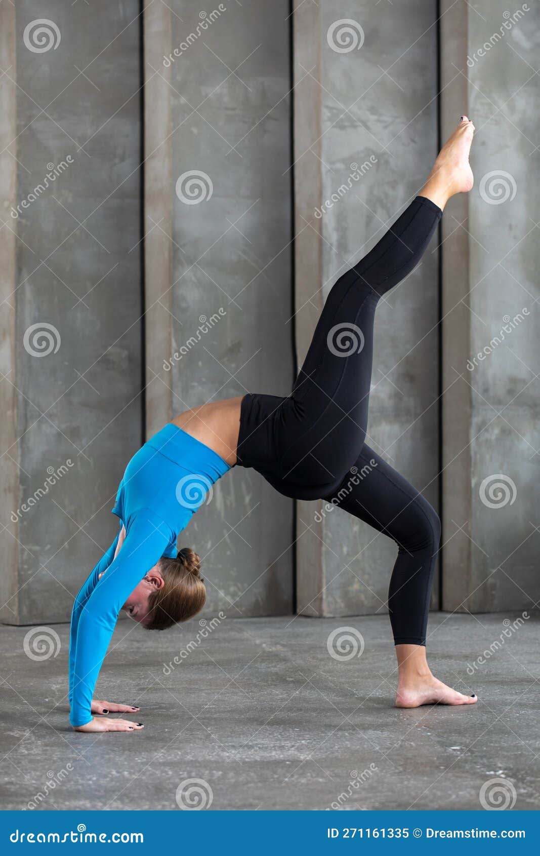 A Young Woman in Sportswear Makes a Gymnastic Bridge. the Concept of ...