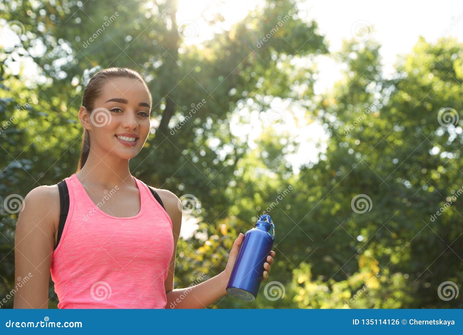 Young Sporty Woman with Water Bottle in Park on Sunny Day. Stock Photo ...