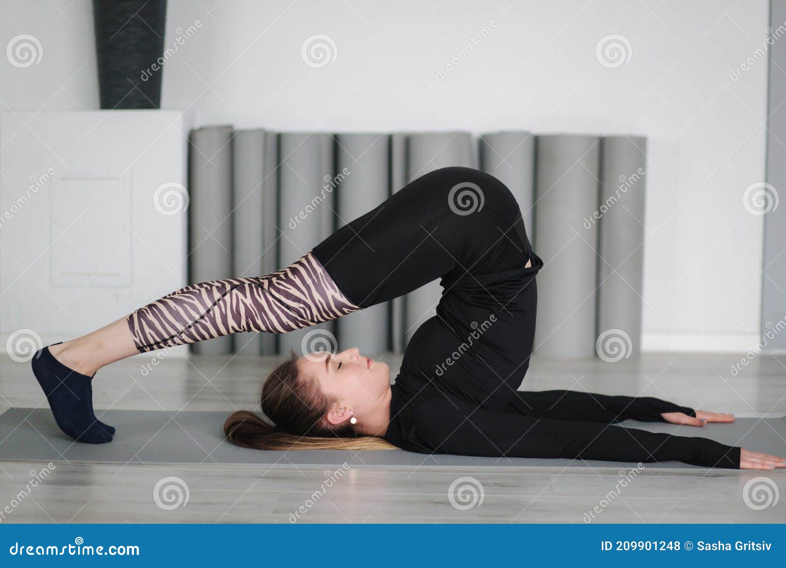 Young Stretching Master Show Differnt Poses for Stretch Stock Photo