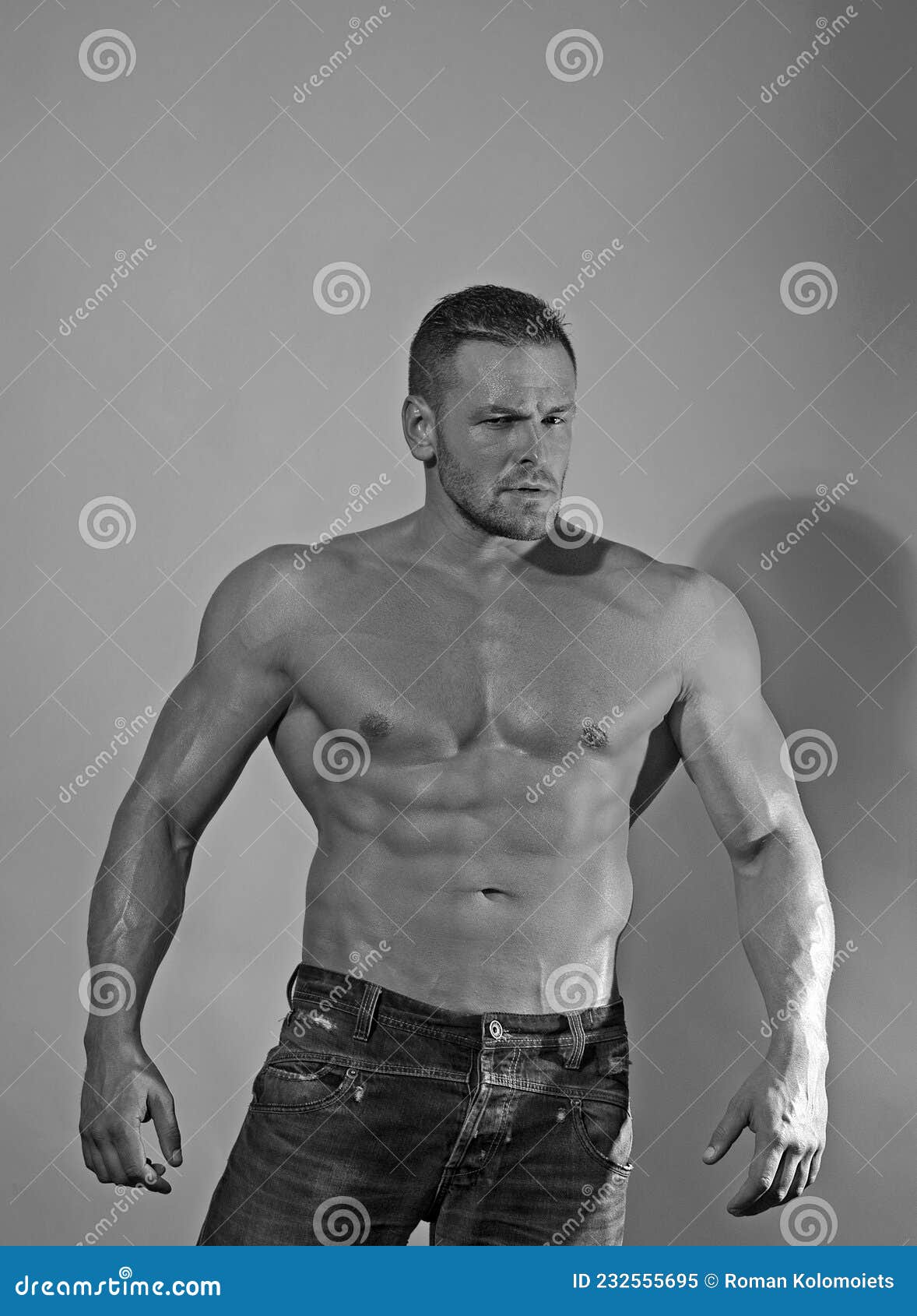 Young Strong Man Bodybuilder on Wall Background Dark Dramatic Colors ...