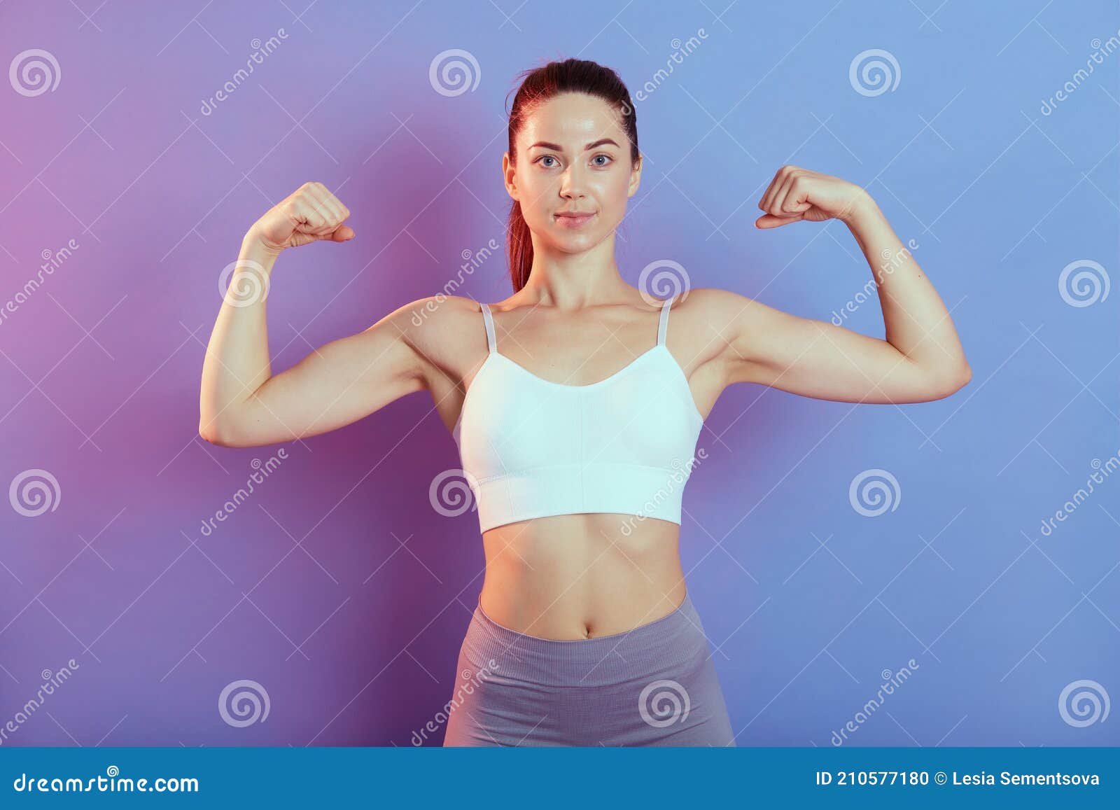 Young Woman Posing And Showing Biceps Stock Photo, Picture and Royalty Free  Image. Image 95690136.