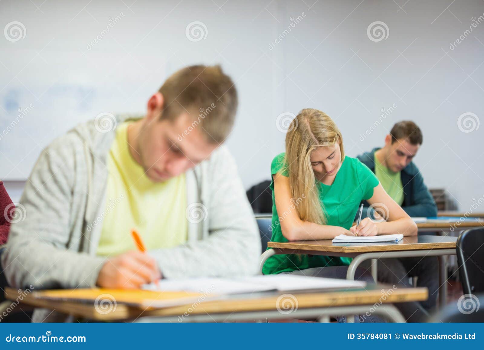 Young Students Writing Notes in Classroom Stock Image Image of sitting, background 35784081